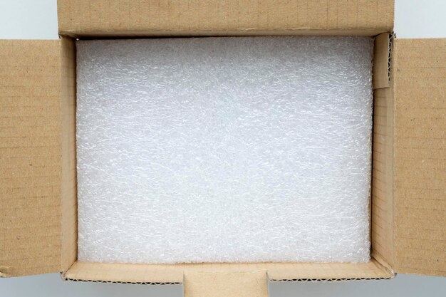 Photo open carton box with soft packing material on the bottom