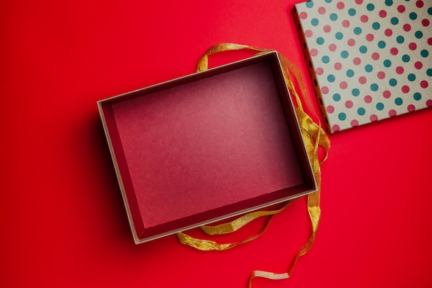 ゴールデン リボンでクリスマス プレゼント ボックス ギフトを開きます。テキスト、カード、バナー、モックアップのためのスペースをコピーします。