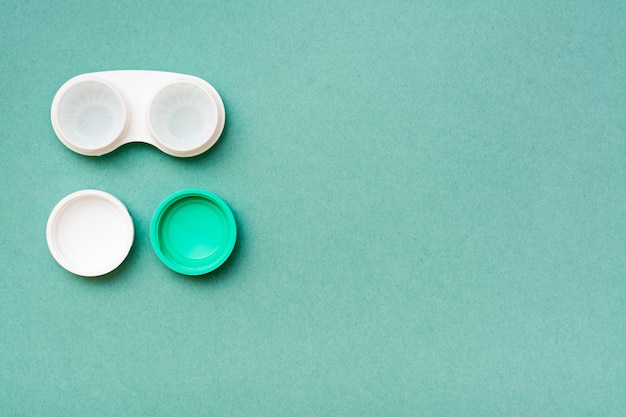 In an open container are lenses in a liquid for cleaning