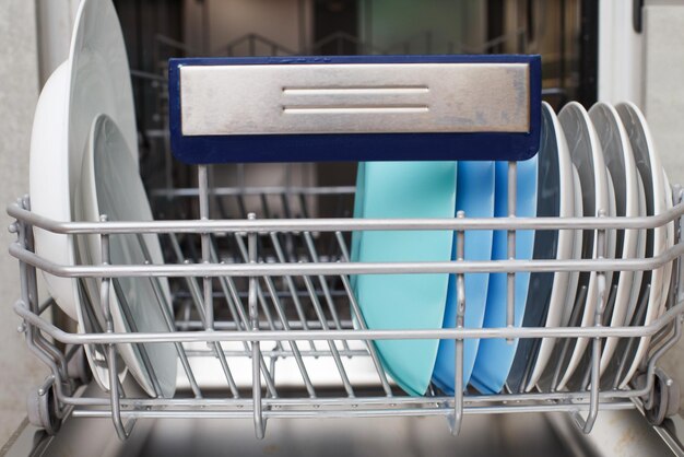 Open dishwasher with clean dishes in the kitchen