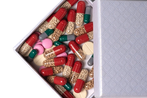 Foto open doos met veelkleurige tabletten, capsules en pillen medicijnen