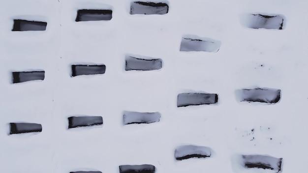 Open empty graves among the snowy field aerial drone view of emty tombs in the winter