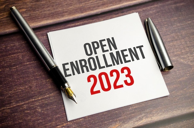 OPEN ENROLLMENT 2023 word on white sticker