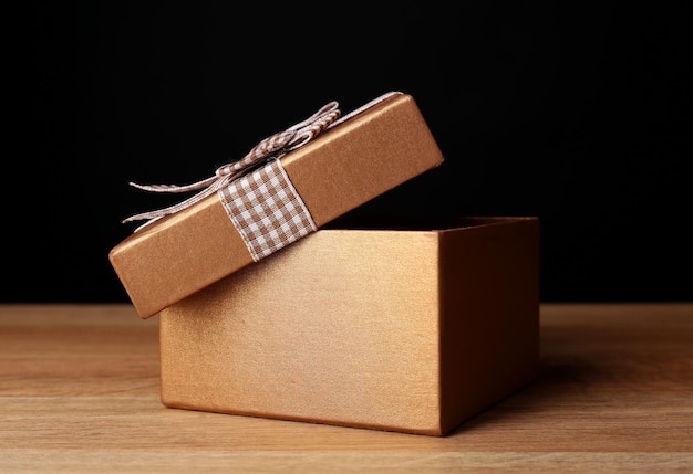 Open gift box on dark background