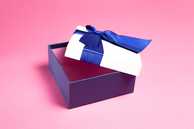 Open gift box on pink