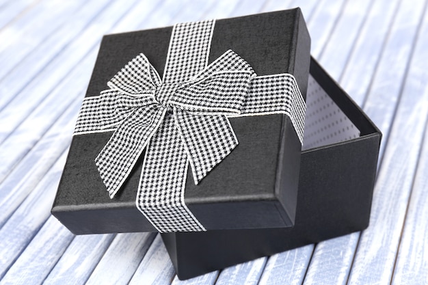 Open gift box on wooden background