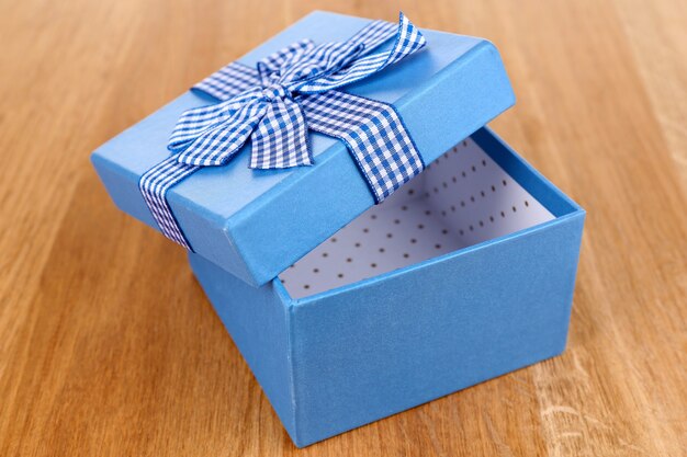 Open gift box on wooden background