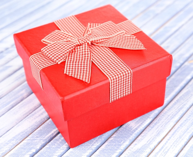 Open gift box on wooden floor