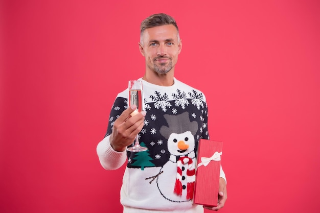 Open gift. Present from Santa concept. Winter sale. Seasonal discount. Diving into christmas mood. Handsome man wear winter sweater. Celebrate new year. Guy in fashionable sweater celebrate winter.