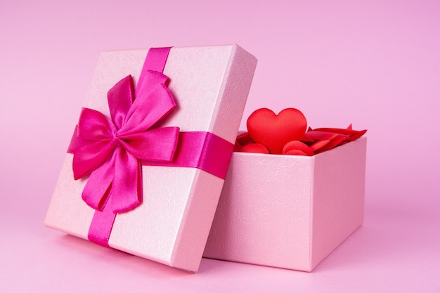 Open gift with heart inside with place for text, concept of valentines day, anniversary and romance.