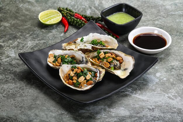 Open half oysters with green onion