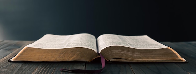 Photo open holy bible on a old wooden table religion concept