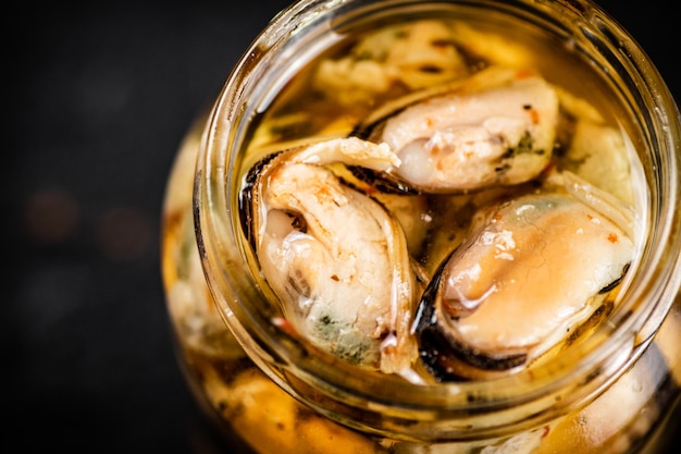 Open jar with pickled mussels