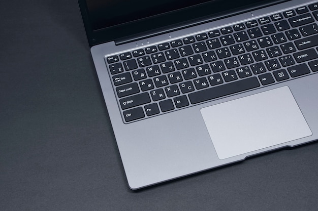 Open laptop on a black background close-up.