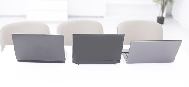 open the laptop on the desktop in a modern office