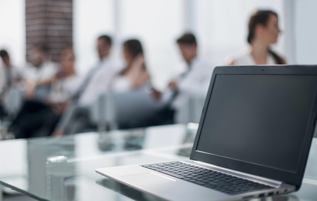 Open laptop on glass office Deskbusiness and technology