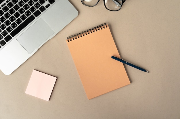 Open laptop with blank notebook, top view. Workplace concept