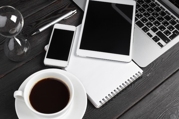 Open laptop with digital tablet and smartphone close up