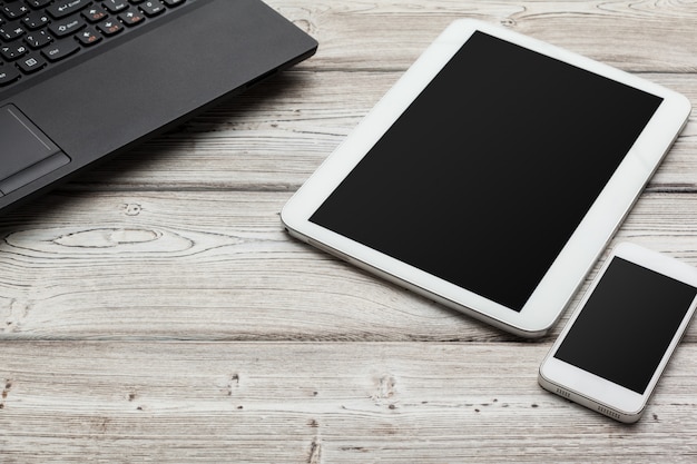 Open laptop with digital tablet on the table