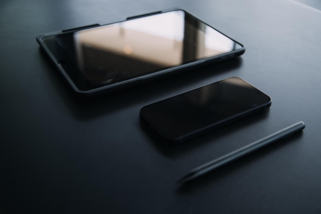 Open laptop with digital tablet and white smartphone All with isolated screen on old wooden desk