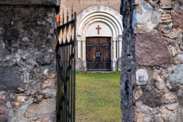 Open metal gate and walkway leading to the entrance to the church selective focus