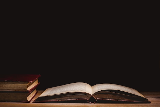 Open a mysterious old book on wooden table