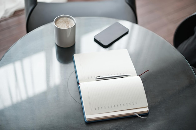 Open notebook on the coffee table closeup