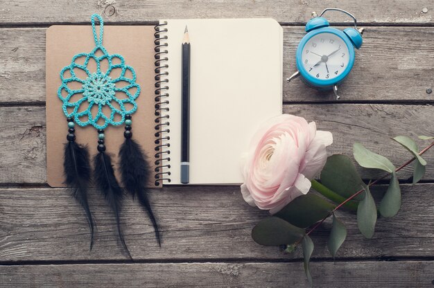 Open notebook, earphones, alarm clock