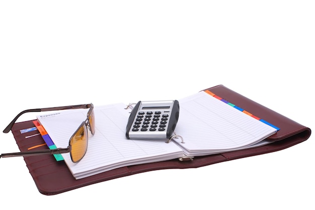 Open notebook glasses and calculator