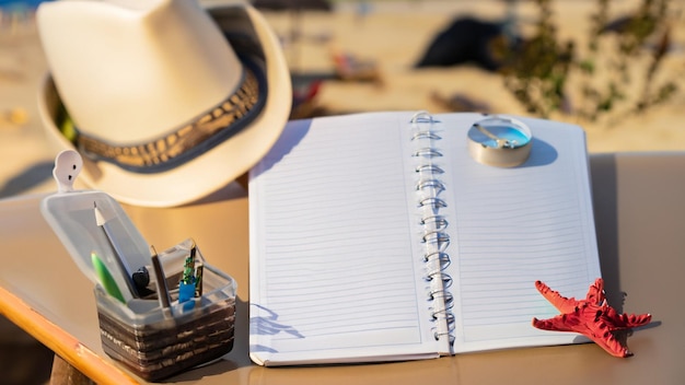 Photo an open notebook laptop above a plastic table water bottle beach background