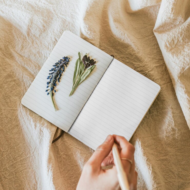 Photo open notebook png mockup with flowers on linen blanket