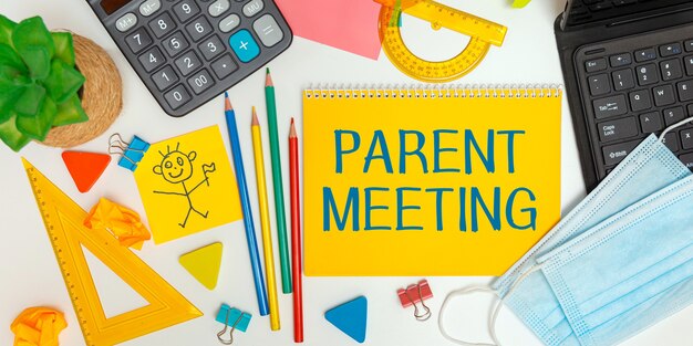 Open notebook with school supplies and the inscription parent meeting