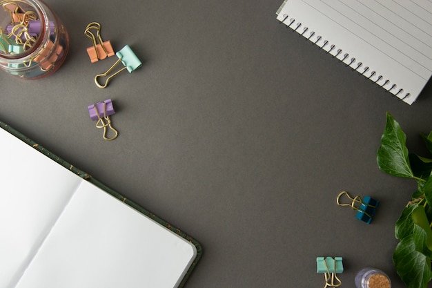 Open notebook, work table, gray background. Creative work space, office supplies.