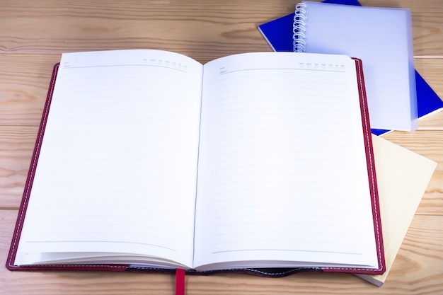 Open notebooks on wooden desk.