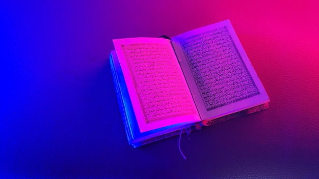 An open page of the Quran Quran is an Islamic holy book for muslim selective focus