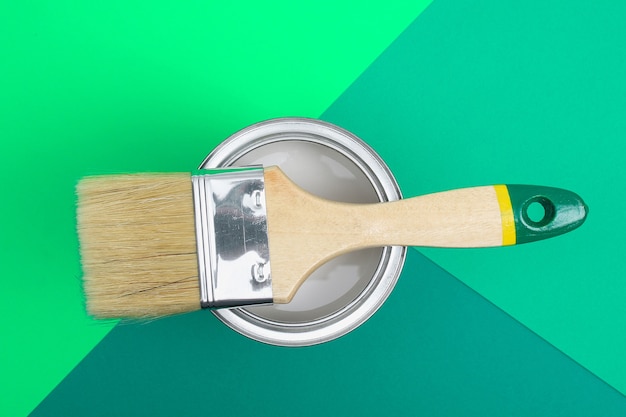 Open paint can with brush