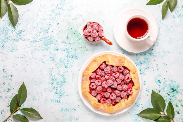 Open pie, raspberry galette. Summer berry dessert.