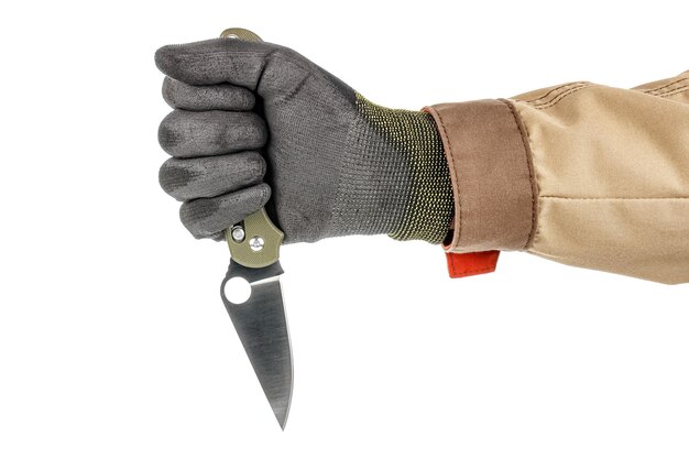 Open pocket folding knife clenched in a male fist in black protective glove isolated on white