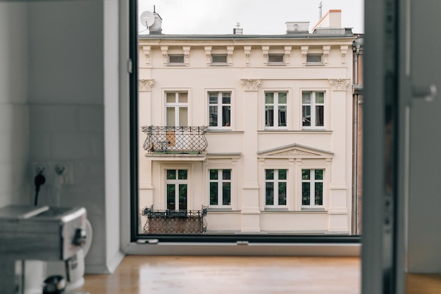 Open raam thuis met uitzicht op de europese straat op het oude appartementsgebouw