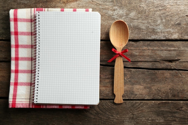 Open recipe book on wooden background