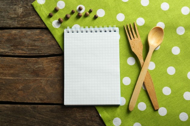 Open recipe book on wooden background