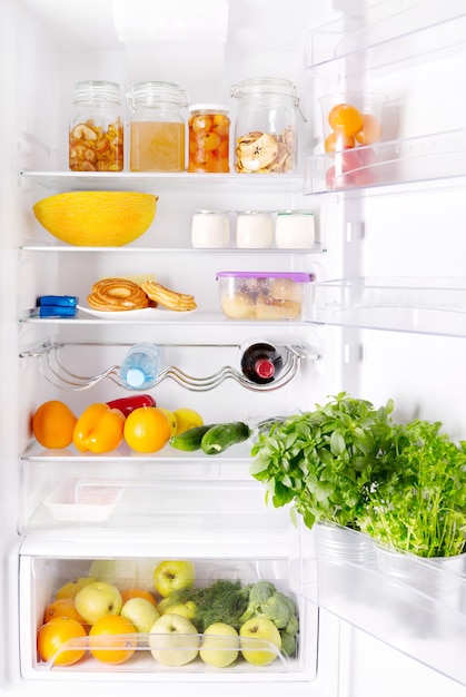 Open refrigerator with various products