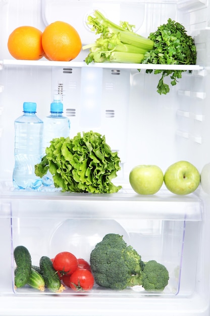 Open refrigerator with vegetarian food