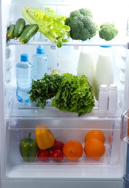 Open refrigerator with vegetarian food