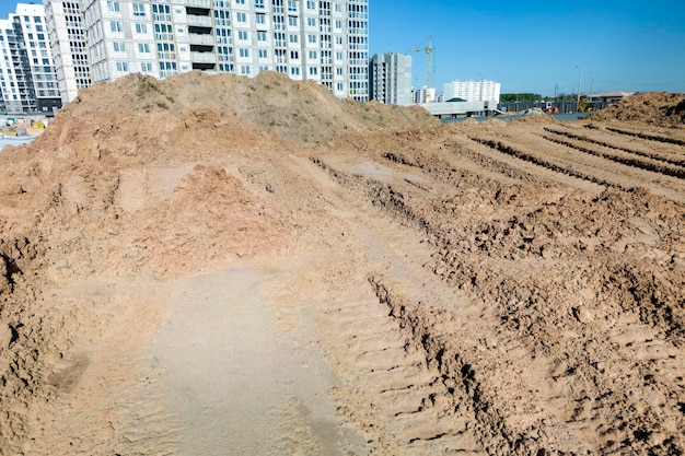 Открытый карьер для добычи песка при строительстве Текстура песка и следы протектора большегрузных автомобилей Песок для строительных работ Хранение песка на стройплощадке