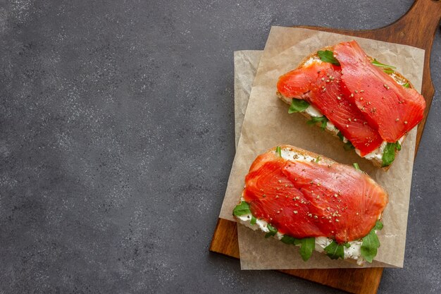 Open sandwiches with salmon, arugula and white cheese. Healthy eating.