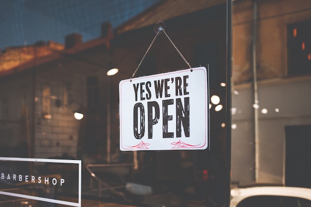 Photo open sign on the black glass in shop