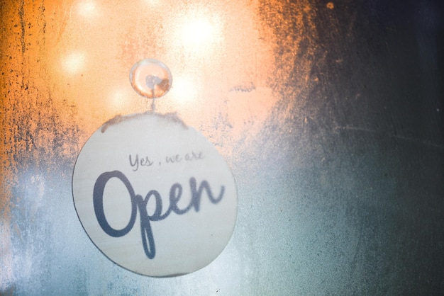 The open sign of the coffee shop in the glass room