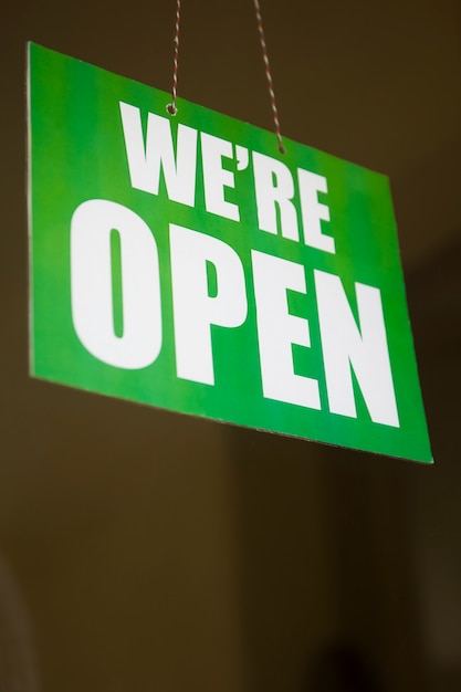 Photo open sign on the glass of the door at store