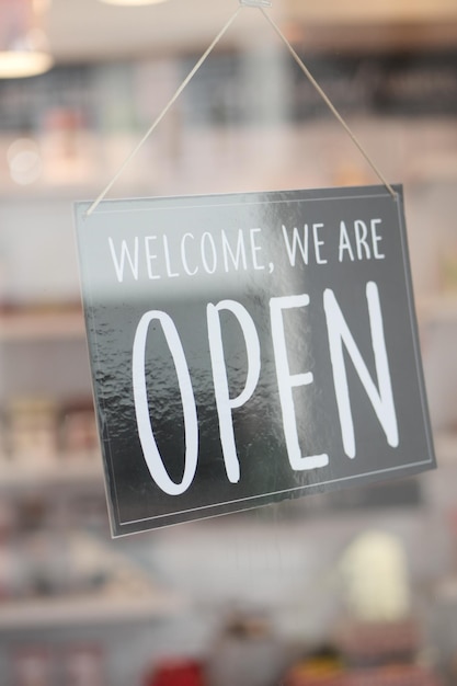 Open sign hanging front of cafe